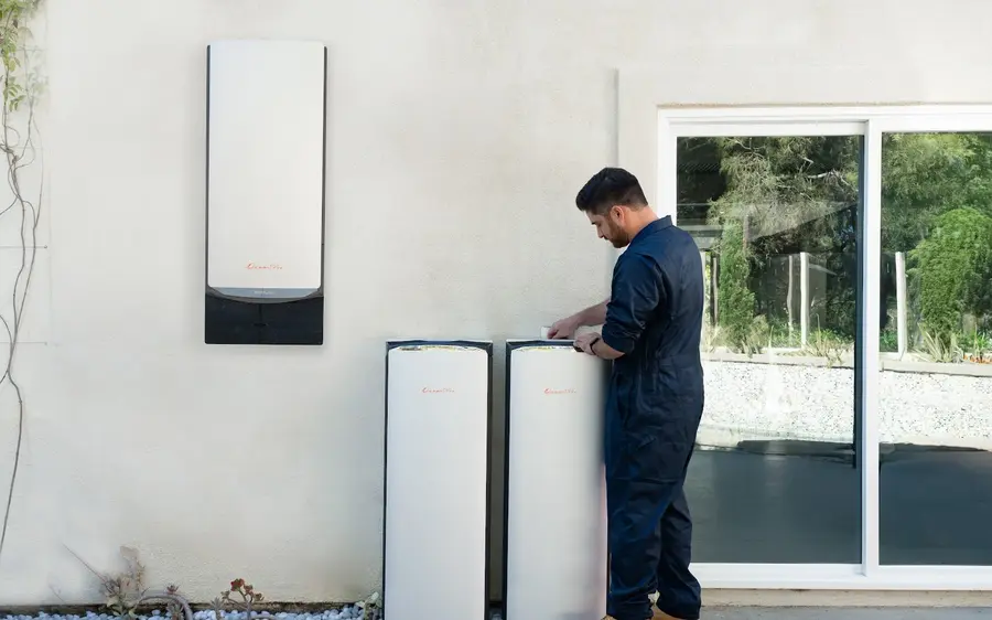 An EcoFlow Ocean Pro home battery installation: a wall mounted inverter unit with two floor standing battery modules beside it.